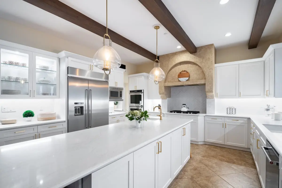 updated remodeled kitchen with white cabinets and white countertops