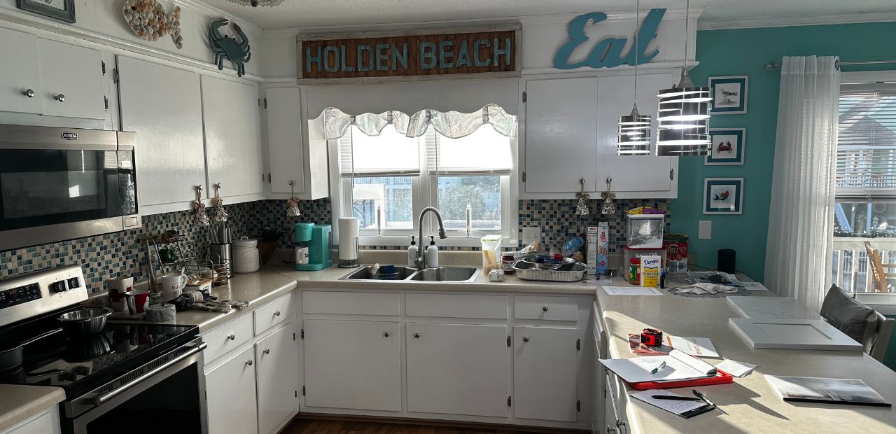 Before the remodel, the kitchen featured older built-in cabinetry, laminate countertops, and a closed-in soffit that limited both visual height and natural light. While the space had charm, it lacked the clean lines, storage efficiency, and modern finishes today’s homeowners expect.