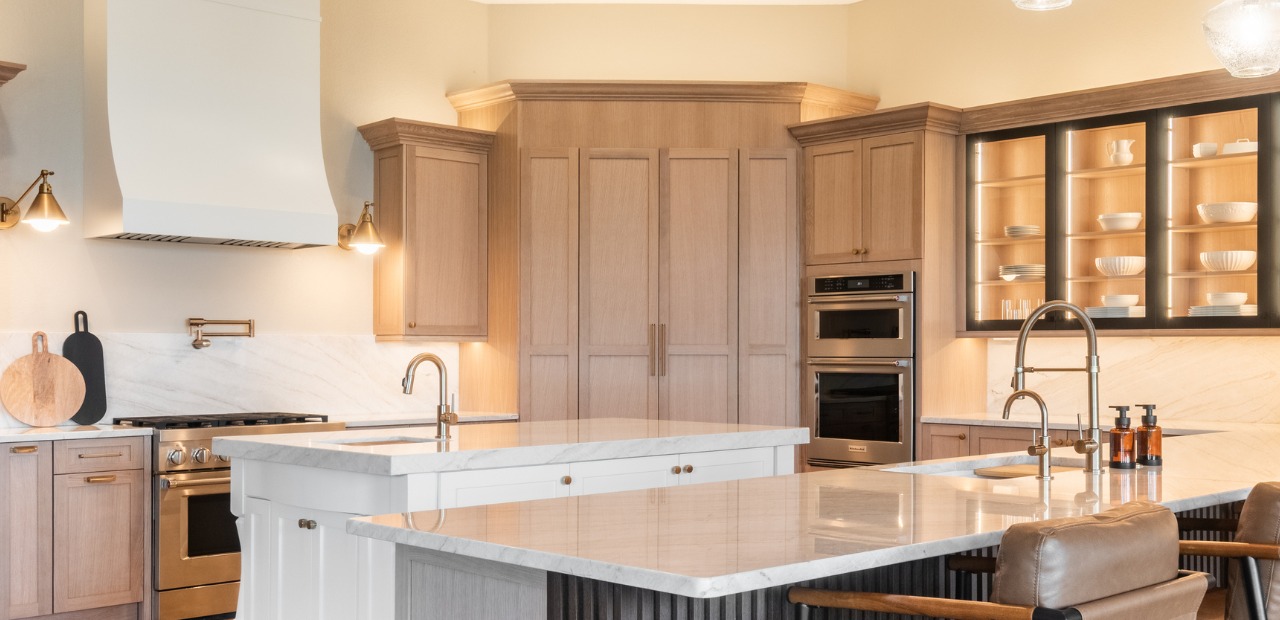 Luxury kitchen in Windermere FL with white oak shaker cabinets, quartzite countertops, glass cabinets and gold hardware