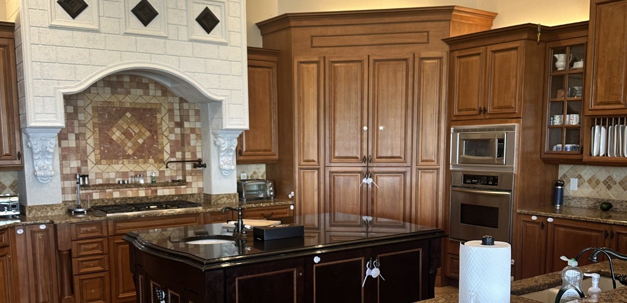 Mediterranean style kitchen in Windermere FL with dark cabinets and inefficient layout
