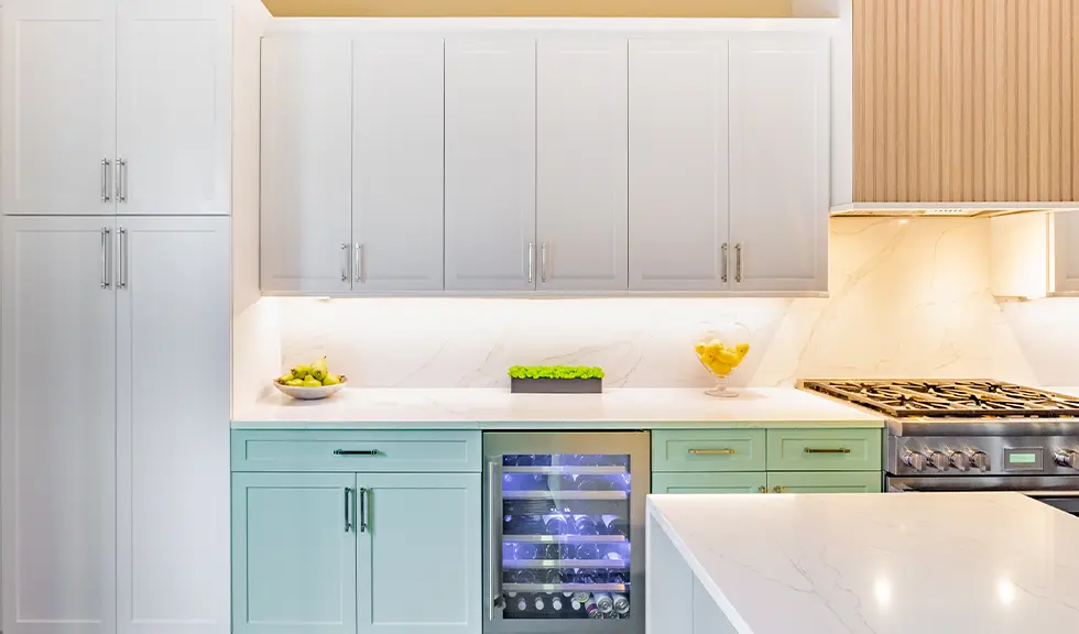 close up view of two tone kitchen with wine cooler, pantry, and gas stove