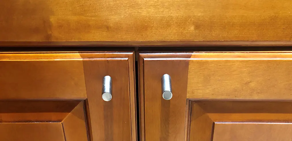 orange kitchen cabinet scratched before reconditioning and tune-up