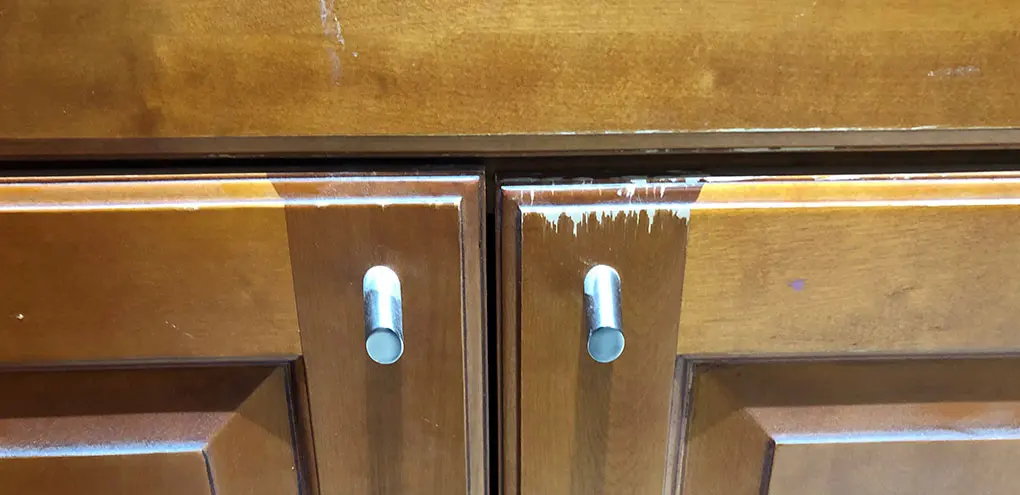 orange kitchen cabinet after reconditioning and tune-up